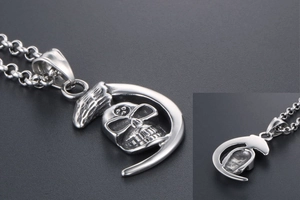 Detailed view of punk style moon skull pendant with polished stainless steel chain