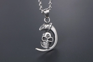 Detailed view of punk moon skull and eagle head pendant with vintage metal finish