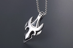 Macro close-up of tribal spearhead pendant in polished steel with black enamel inlay