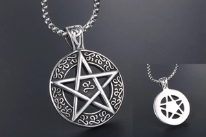 Detailed view of vintage star pendant showing the front texture and back structure