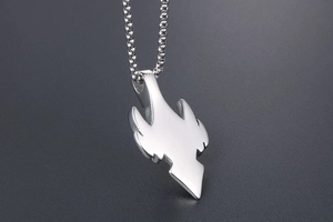 Detailed view of silver stainless steel wolf fang pendant on a delicate chain