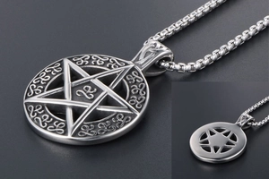 Macro view of stainless steel pentagram pendant with Celtic knot patterns on a box chain