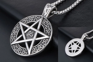 Close-up of silver star pendant with Celtic patterns and textured metal chain