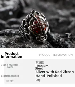 Detail of gothic stainless steel ring with red zircon stone and cross on dark rock