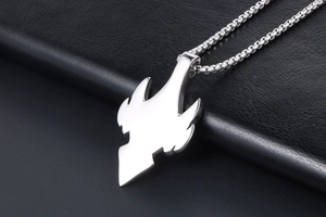 Detailed close-up of a silver titanium steel pendant with a sharp wing-shaped flame design