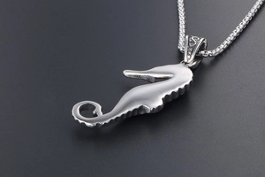 Detailed view of seahorse pendant with polished finish and O-chain in stainless steel