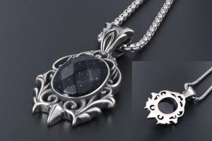 Macro view of retro stainless steel teardrop pendant with starry blue sandstone inlay