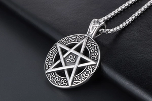 Macro view of pentagram star pendant with Celtic knots and sturdy steel box chain