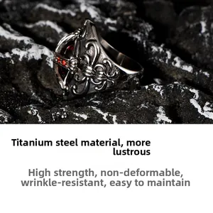 Detail of gothic titanium steel ring with red gemstone and vintage floral carvings