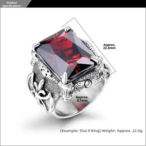 Macro detail of gothic titanium steel ring with large red ruby stone inlay and carvings