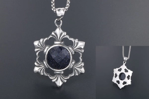 Macro view of vintage snowflake pendant featuring blue sandstone and silver-tone engraving