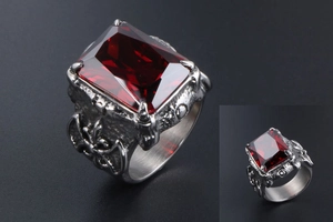 Detailed view of gothic silver titanium ring featuring a large faceted red gemstone inlay
