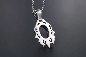 Detailed back view of teardrop pendant featuring hollow carving and blue sandstone