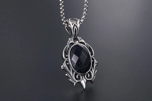 Macro shot of vintage teardrop pendant with blue sandstone and silver filigree metal