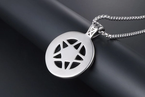 Detailed view of a silver pentagram star pendant on a square foxtail chain
