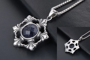 Macro shot of blue sandstone pendant with ornate hollow silver-tone frame and box chain