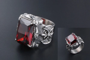Macro detail of men's vintage gothic ring featuring a large red ruby and claw setting
