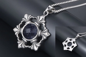 Macro shot of gothic flower pendant with blue sandstone and vintage steel chain detail