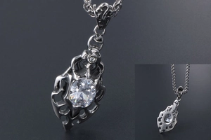Macro detail of gothic flame pendant with large white zircon on stainless steel chain
