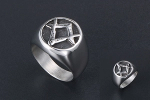 Macro detail of silver titanium steel ring featuring a vintage engraved Masonic emblem