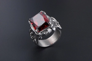 Macro shot of men's vintage steel ring with square ruby stone and gothic carving