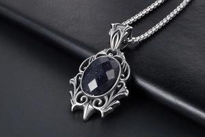 Detailed view of teardrop blue sandstone pendant with retro silver floral steel frame