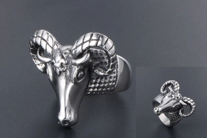 Detail of silver antelope head ring with spiral textured horns and vintage rock style
