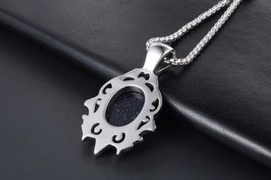 Macro detail of retro water drop pendant with glittering blue sandstone in silver box chain
