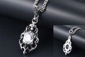 Macro shot of silver flame pendant with oval zircon and hollow punk metal details
