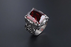 Detail shot of gothic titanium steel ring featuring a large rectangular red ruby inlay