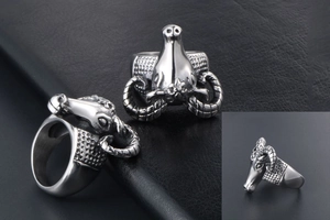 Macro detail of retro punk goat head ring with carved horns on black leather background