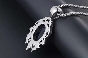 Detailed macro view of the hollow-out metal pattern on the back of a vintage blue stone pendant