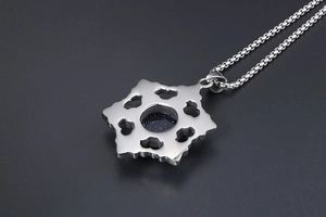Close-up of titanium steel necklace showing hollow pattern and blue sandstone detail