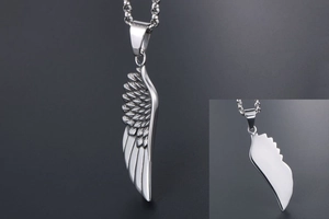 Close-up of wing pendant texture and smooth back on titanium steel chain necklace