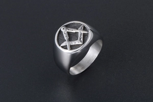 Macro shot of silver titanium Freemason ring showing compass and square engraving