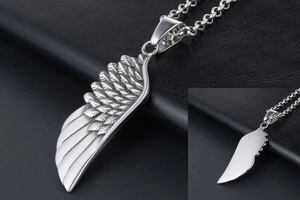 Detailed view of silver wing pendant with intricate feathers on black leather