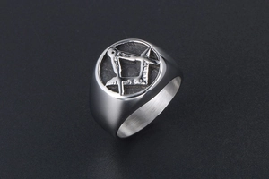 Macro detail of silver titanium ring featuring embossed Freemasonry compass and square symbol