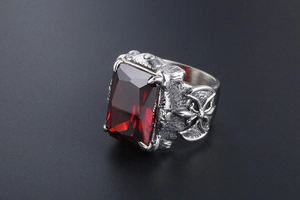 Macro shot of men's gothic ring with rectangle red gemstone and eagle claw setting
