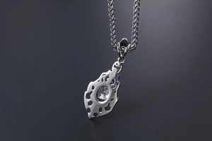 Macro view of silver stainless steel flame necklace with clear zircon stone detailing