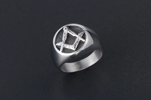 Macro shot of silver titanium steel men's ring featuring the Freemasonry symbol engraving