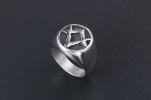 Detailed view of silver signet ring with engraved Masonic compass and square symbol