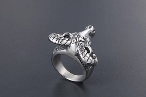 Detailed close-up of a silver goat head ring with intricate punk rocker textures