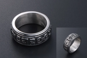 Macro shot of punk titanium steel ring with Buddhist mantra relief and beaded edges