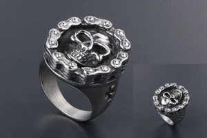 Macro shot of punk style skull ring with motorcycle chain design in matte steel finish
