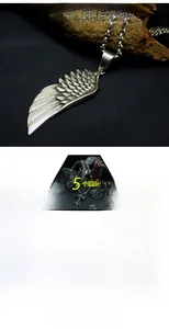 Macro detail of vintage wing pendant in titanium steel with durable antique silver finish