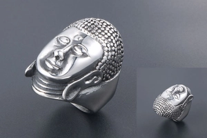 Macro shot of silver Buddha head ring in stainless steel with detailed textures