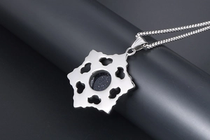 Detail view of silver titanium steel pendant with blue sand stone and hollow snowflake back