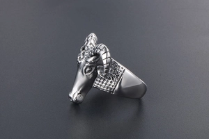 Side view of a vintage silver ram head ring with detailed horns and rustic finish