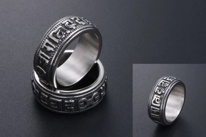 Detail of vintage titanium steel ring featuring embossed Buddhist Six Word Mantra
