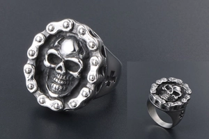 Close-up of gothic skull ring with chain border and cross cutout in vintage steel